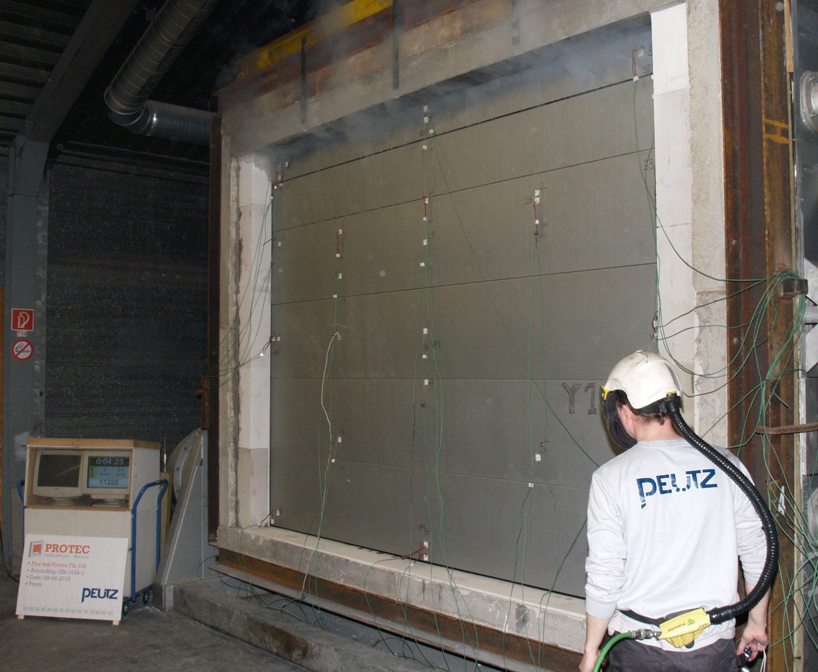 Fire resistant sectional door during the fire test; Tested and certified fire-resistance